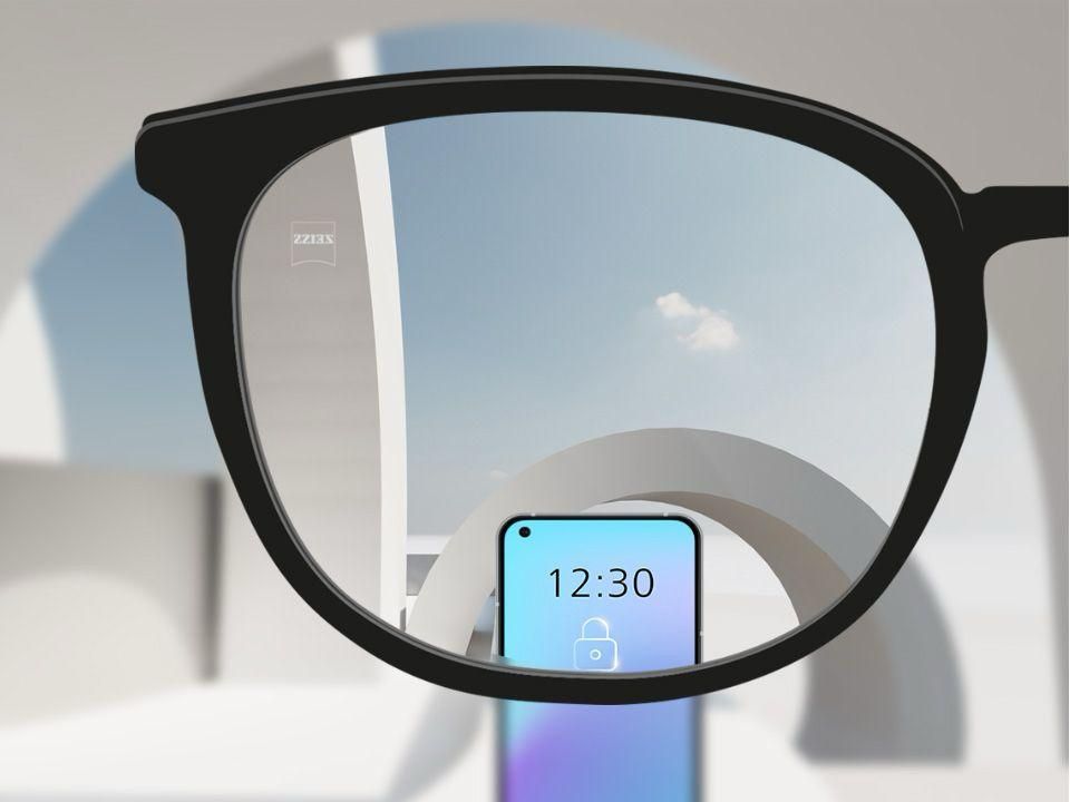 Single vision lens shown through black eyeglasses frame demonstrating clear vision at one distance, with a smartphone screen visible in focus while the background remains slightly blurred, illustrating one of the natural ways to maintain healthy vision with proper prescription lenses.