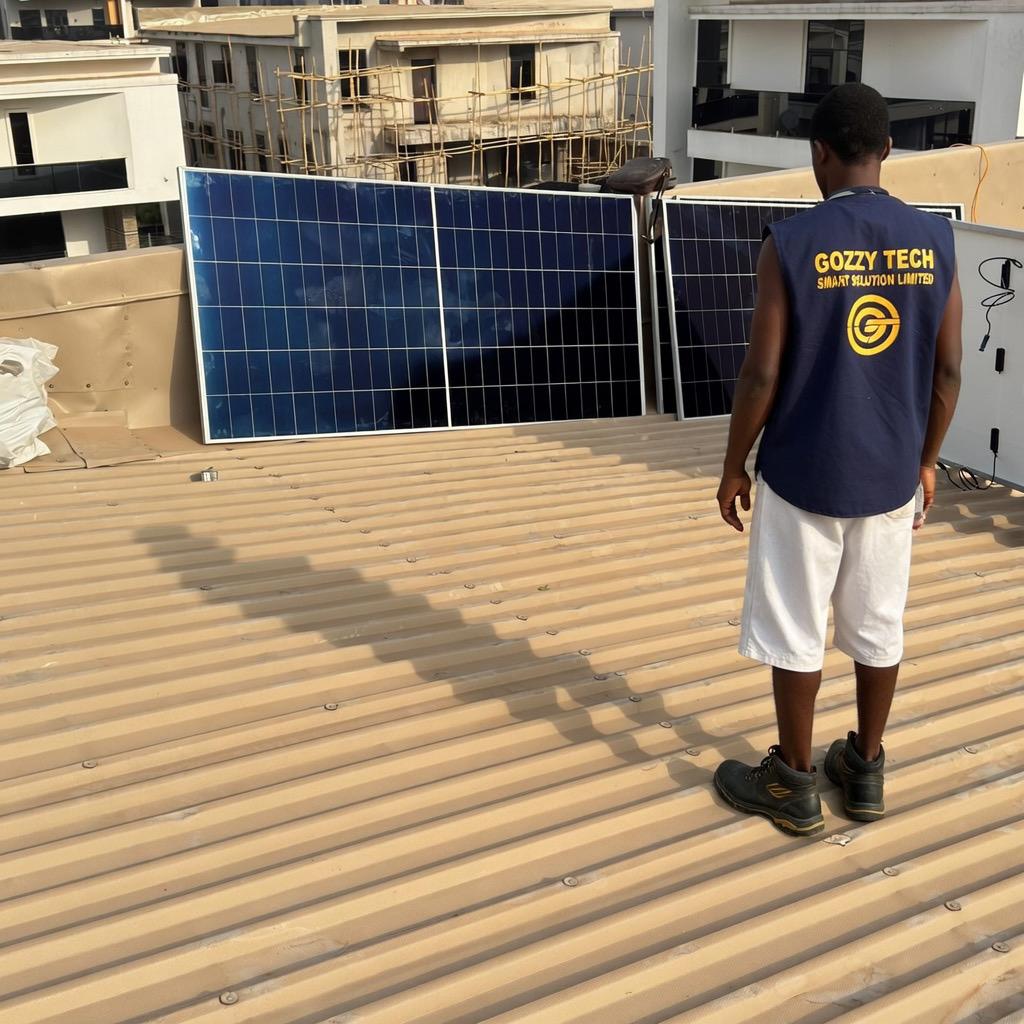 A certified solar installation professional conducting a safety inspection on a rooftop PV system in Nigeria.